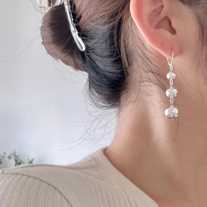 Minimalist S925 sterling silver triple ball drop earrings worn on model for modern style
