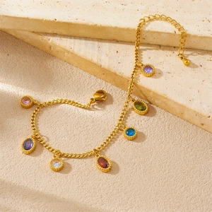 Elegant gold stainless steel bracelet with colorful oval crystal charms on stone surface