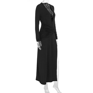 Detail of elegant black long-sleeve maxi dress with deep V-neck and waist pleats