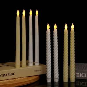 Close-up of LED electronic candles with smooth and spiral textures on a dark background
