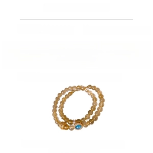 Detail of beaded bracelet with gold hollow beads, blue zircon, and hair crystal info