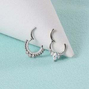 Detail view of silver stainless steel septum rings with zircon flower and beads
