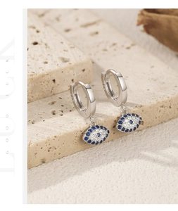 Macro shot of S925 sterling silver evil eye earrings with blue zircon on stone base