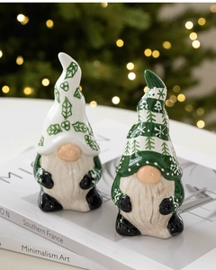 Close-up of ceramic Christmas gnomes with glossy finish on a cozy festive tabletop