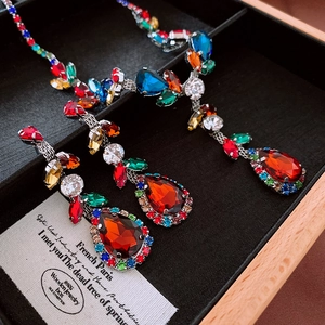 Macro shot of vintage necklace and earrings set with red teardrop stones in a gift box