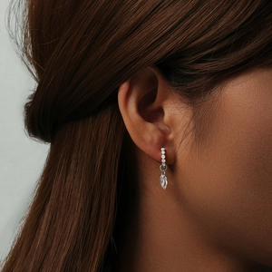 Close-up of s925 silver vintage heart drop earrings with zircon inlays and waterdrop charm