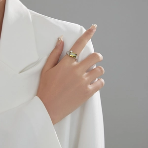 Close-up of silver ring with large rectangular green stone and twisted chain band