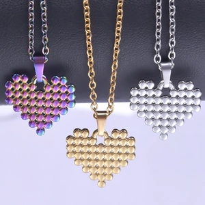 Three beaded heart necklaces in rainbow, gold, and silver finishes on a display
