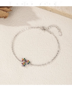 Detail of S925 silver bracelet with colorful star charm and lobster clasp closure