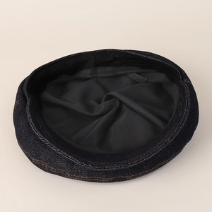 Dark blue denim newsboy cap with yellow contrast stitching and soft lining for women