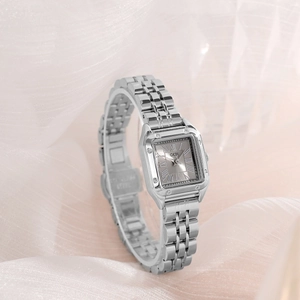 Elegant square silver quartz watch for women with stainless steel band on soft fabric