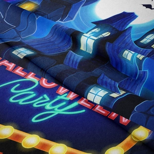 Detail of soft Halloween tapestry showing neon party text and spooky castle print texture