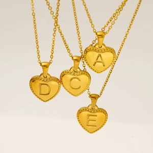 Gold stainless steel heart necklaces with engraved initials and beaded edges