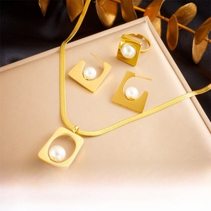 Detailed view of irregular gold square jewelry set with white pearls and necklace details