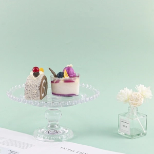 Detailed close-up of realistic faux cake and blueberry pudding dessert props for display