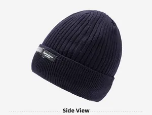 Side view of navy blue knitted beanie showing thick vertical texture and textile label