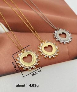 Detailed view of heart-shaped zircon pendants with sunburst design on necklaces