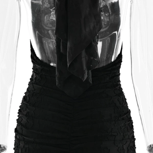 Detail of ruched black backless halter dress showing 3D fabric texture and back tailoring