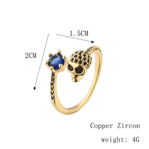 Macro shot of copper skull ring with micro-paved blue zircons showing precise 2cm height