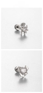 Detail view of silver angel stud earrings with heart-shaped zircon and screw back closure