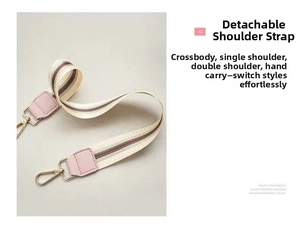 Detail of detachable fabric shoulder strap with red and green stripes and gold clasp