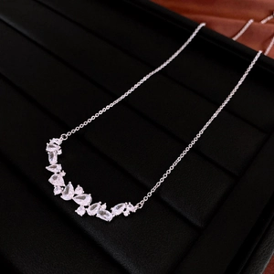 Close-up of silver necklace with teardrop cubic zirconia on a black display stand