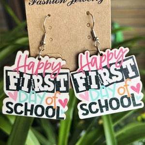 Detail showing wooden earrings with Happy First Day of School print on display card