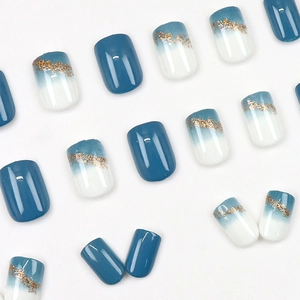 Short square press-on nails in dusty blue with glitter accents and gradient design