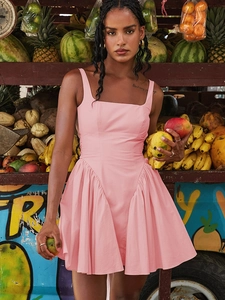 Pink sleeveless square neck dress with a cinched waist and pleated skirt on a model