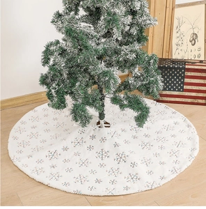 Detailed view of white plush Christmas tree skirt with silver and blue snowflake sequins