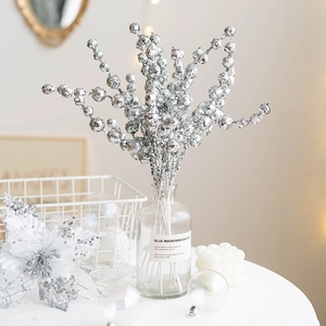 Silver glitter Christmas berry stems in a glass vase for minimalist holiday home decoration