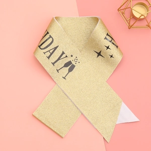 Glittering gold Birthday Girl sash with black lettering and champagne star patterns
