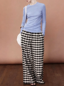 Detail of light blue long sleeve top with textured bamboo pattern and plaid wide-leg pants