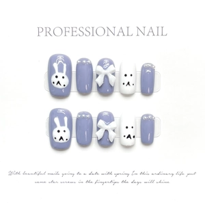 Detail of lilac and white press-on nails with 3D bows, pearls, and cute bunny art