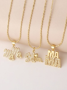 Close-up of three gold-plated necklaces with MAMA pendants and sparkling zircons