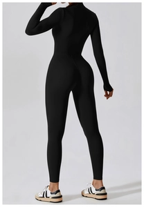 Back view of a sleek black high-stretch yoga jumpsuit showing ergonomic seams and fit