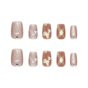 Pink and champagne cat-eye press-on nails set with glitter, butterfly and rhinestone accents