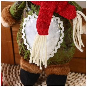 Close-up of Christmas plush doll with red scarf and transparent heart window apple bag