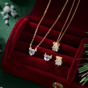 Detailed view of gold S925 silver Christmas elk necklace and earrings in a red gift box