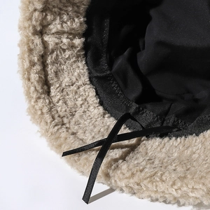 Plush beige faux lamb wool bucket hat with black adjustable drawstring and warm lining