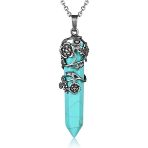 Detail of vintage silver flower vine wrapped around a hexagonal turquoise stone pendant