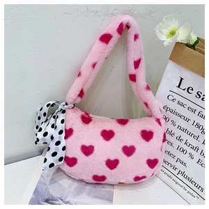 Detail of pink faux fur heart bag featuring decorative silk scarf and soft texture