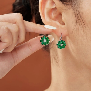 Sparkling green flower stud earrings with zircon petals on model for elegant styling