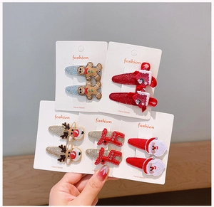 Detailed set of Christmas hair clips featuring reindeer, Santa, and gingerbread designs