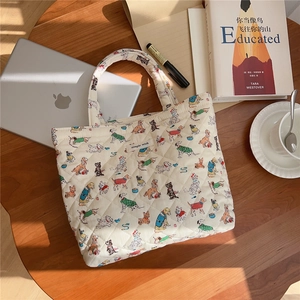 Close-up of quilted cotton tote bag with puppy prints and simple wish label detail