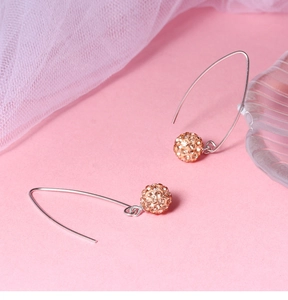 Close-up of S925 silver long hooks with champagne crystal pavé disco ball drops