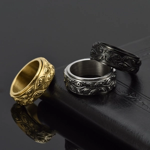 Set of rotatable stainless steel evil eye rings in gold, silver, and black finishes