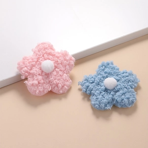 Detail of soft 8cm teddy fleece flowers in pink and blue with white center stamens