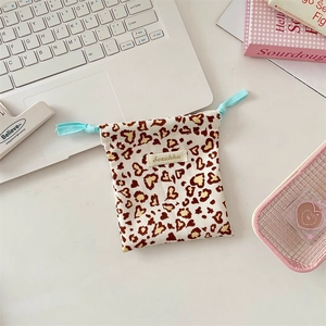 Detail of drawstring pouch with heart leopard print and mint green braided cord