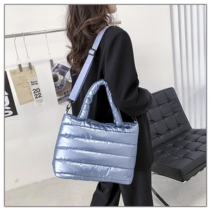 Quilted light blue puffer shoulder bag with metallic finish and adjustable strap
